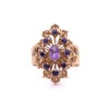 A 9ct gold cocktail ring set with amethysts, the navette-shaped head centred with an oval-cut