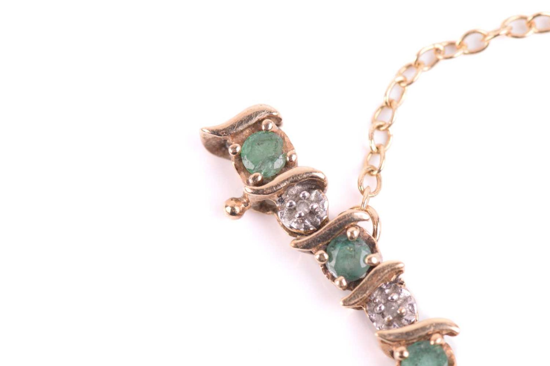 An emerald and diamond line bracelet in 9ct gold, with alternating circular-cut emeralds and - Image 6 of 7