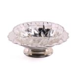 A silver fruit bowl, circular with scalloped border and depressed centre, on circular skirt foot.