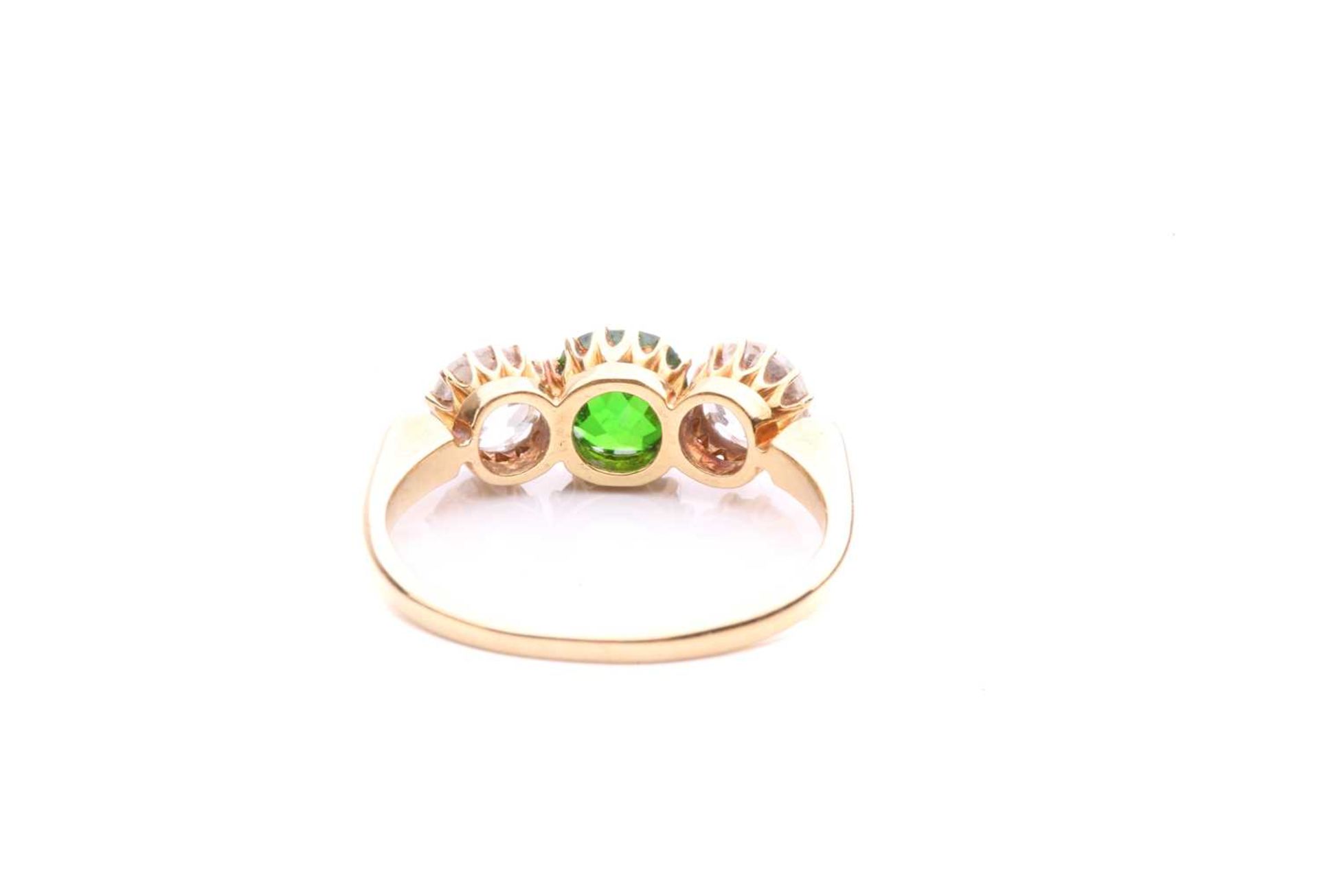 A tsavorite and diamond three-stone ring, centred with a circular-cut tsavorite in intense green - Image 5 of 5