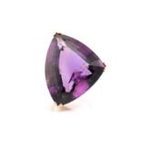 A large amethyst cocktail ring, featuring a trillion-cut amethyst of 32.6 x 25.7 x 14.7 mm, with