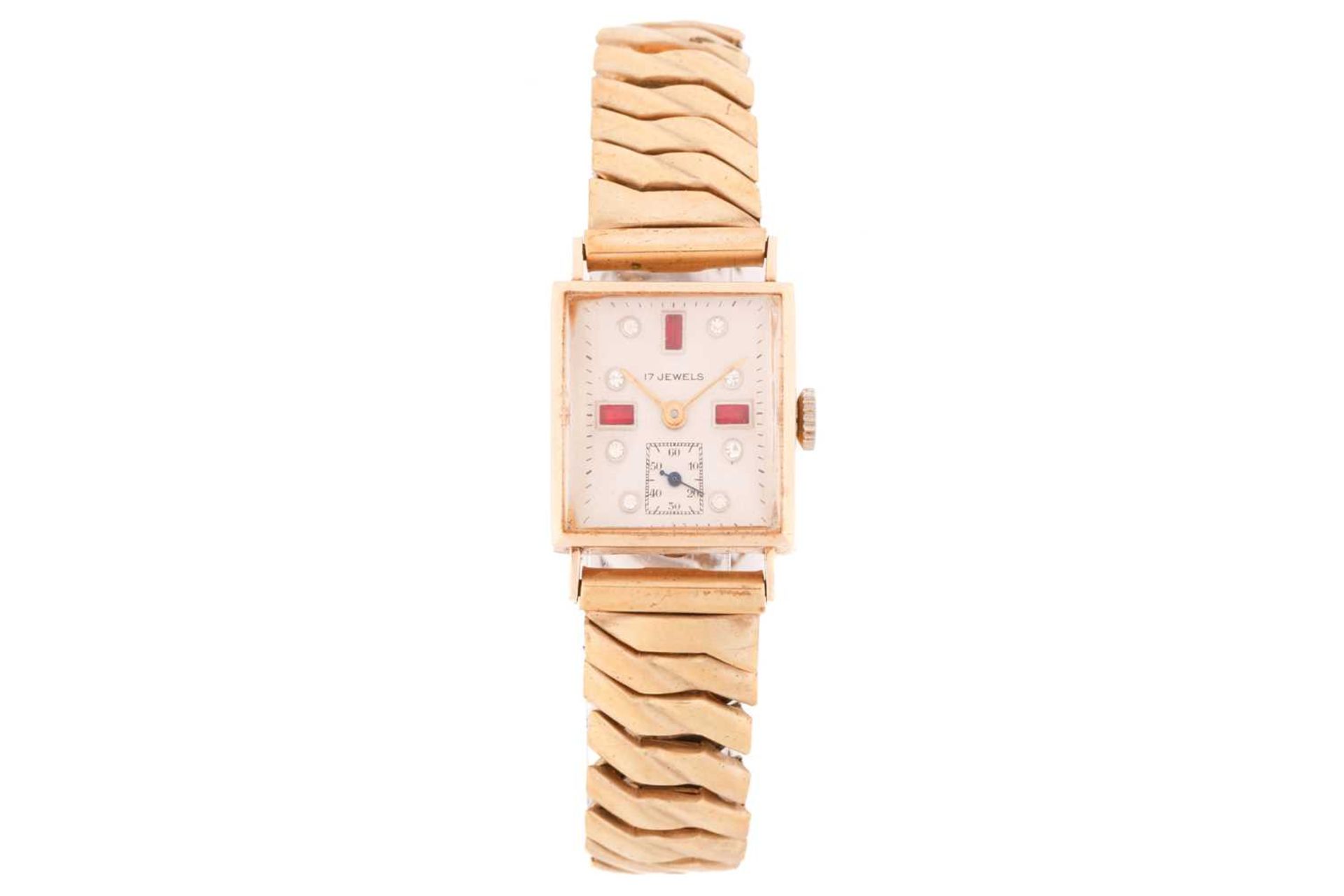 An Art Deco ladies 14k yellow gold wristwatch, on a gold-plated steel expanding bracelet, with