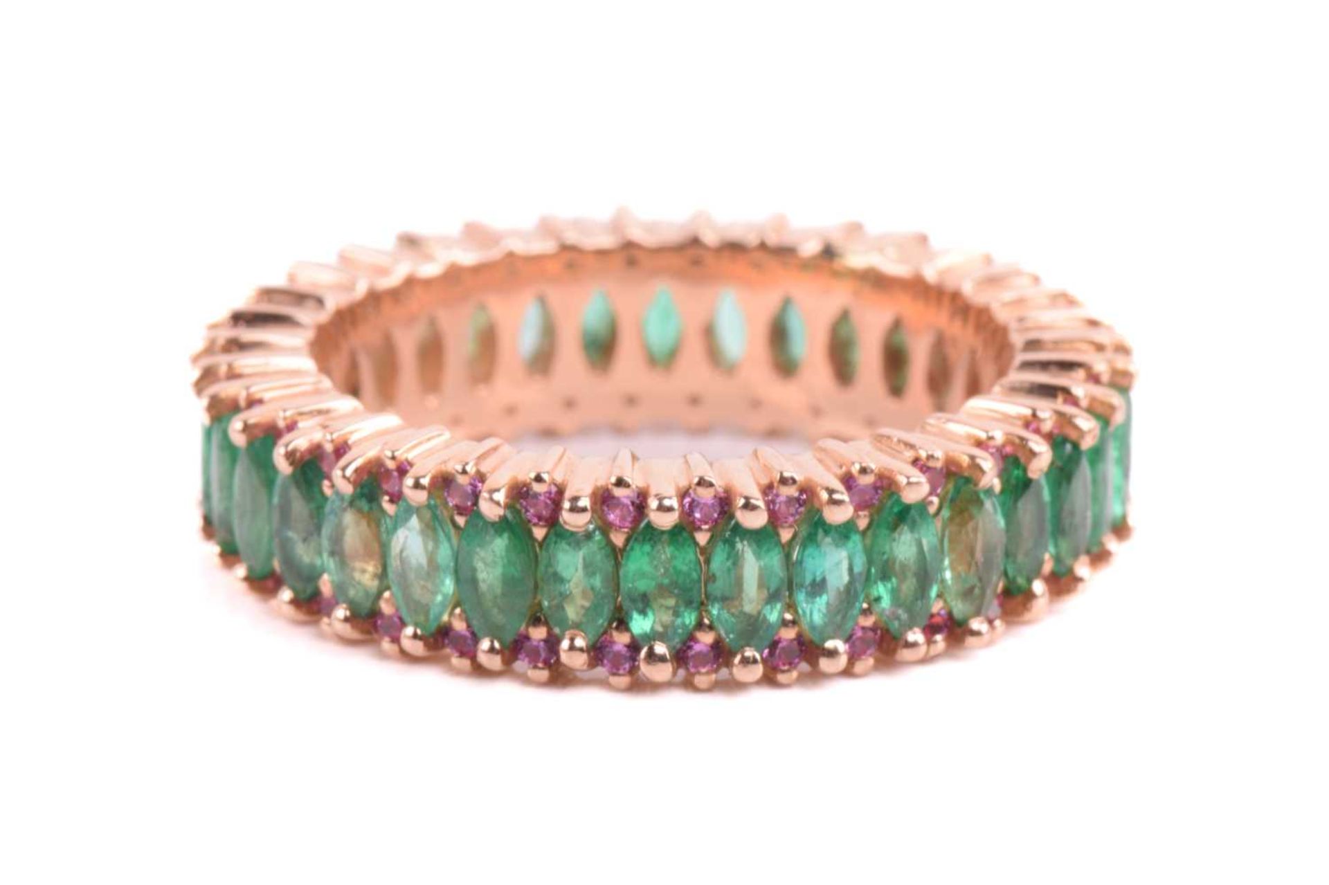 An emerald and pink sapphire eternity ring, centrally set with a row of marquise-cut emeralds,