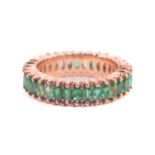 An emerald and pink sapphire eternity ring, centrally set with a row of marquise-cut emeralds,
