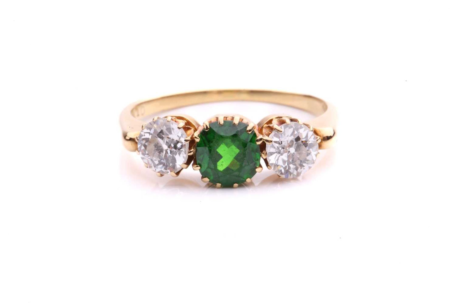 A tsavorite and diamond three-stone ring, centred with a circular-cut tsavorite in intense green