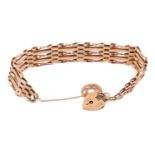 A five-row gate link bracelet with charm in 9ct yellow gold, of twist design, together with a Star