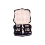 A silver six piece cruet set in fitted case the salts and mustard pots with blue glass liners,