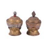 A close pair of Tibetan kapala and stands, early 20th century, each with cast vajra knop above an