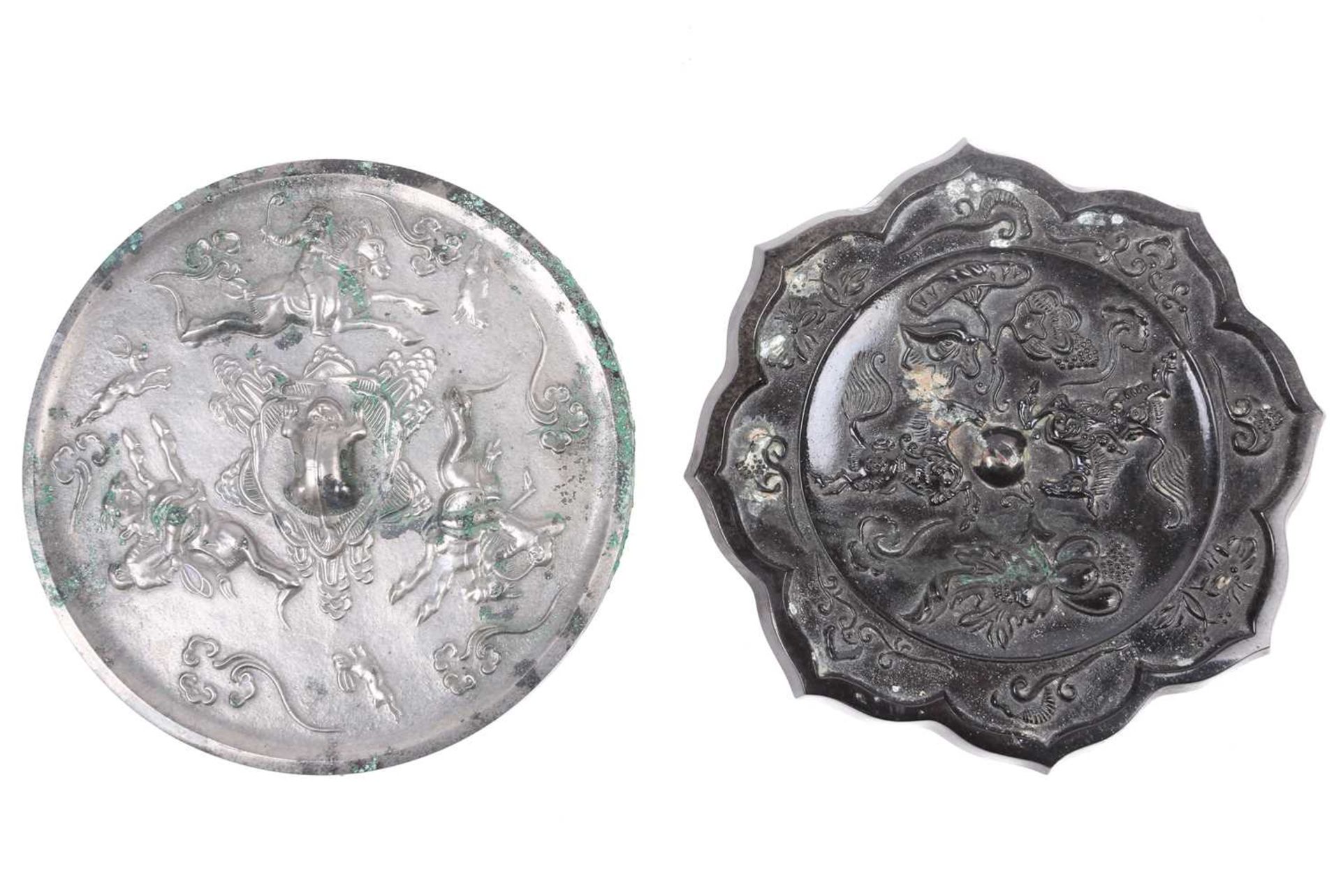 A Tang style bronze mirror, relief cast with two opposing horses, amongst lotus and gourds, the