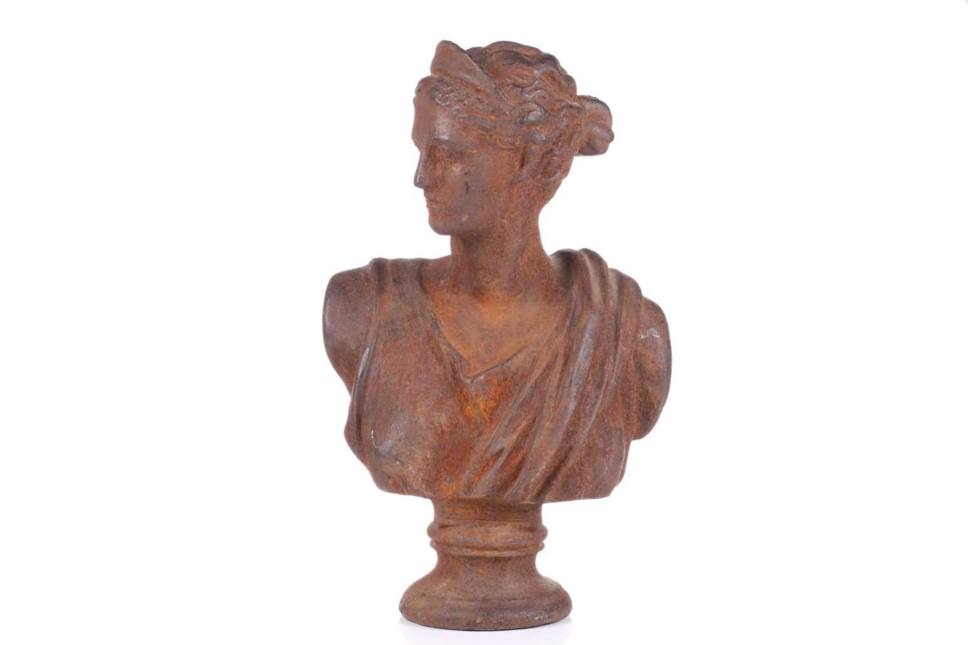 A classical cast iron bust study of Diana the Huntress on a concave moulded socle. 52 cm high.