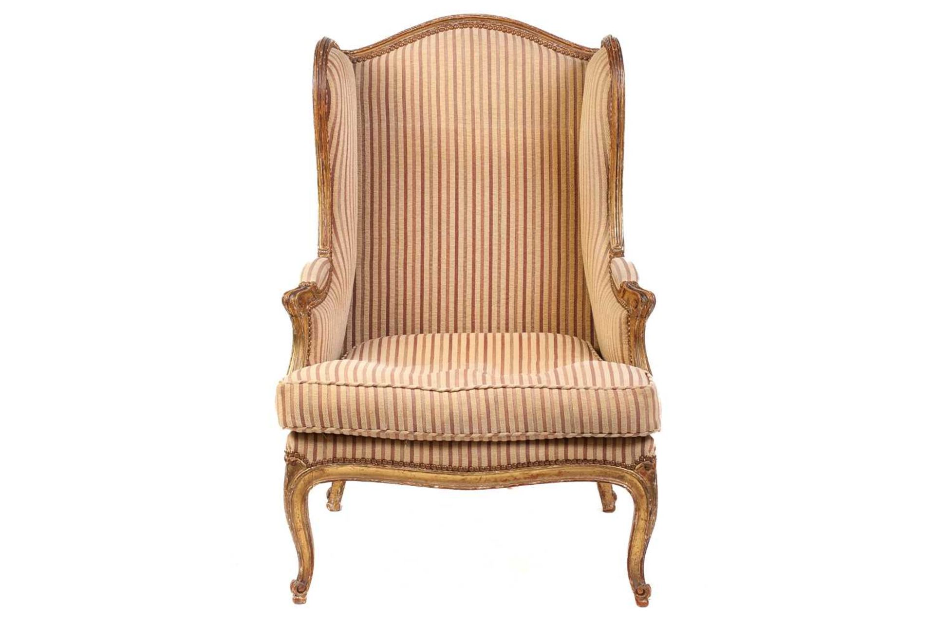 A Louis XV style bergere wing chair, 19th century, with carved wood and gilt gesso frame and striped - Image 2 of 9
