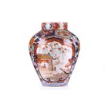 A large Japanese Imari pattern vase, with two reserves decorated with birds and figures in a