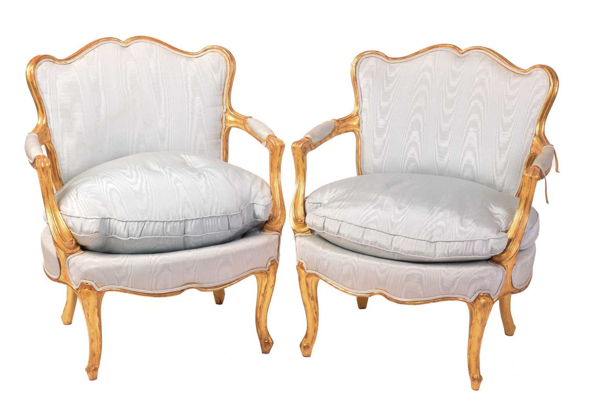 A pair of French Louis XV-style carved wood and gilt gesso fauteuils, 20th century with serpentine