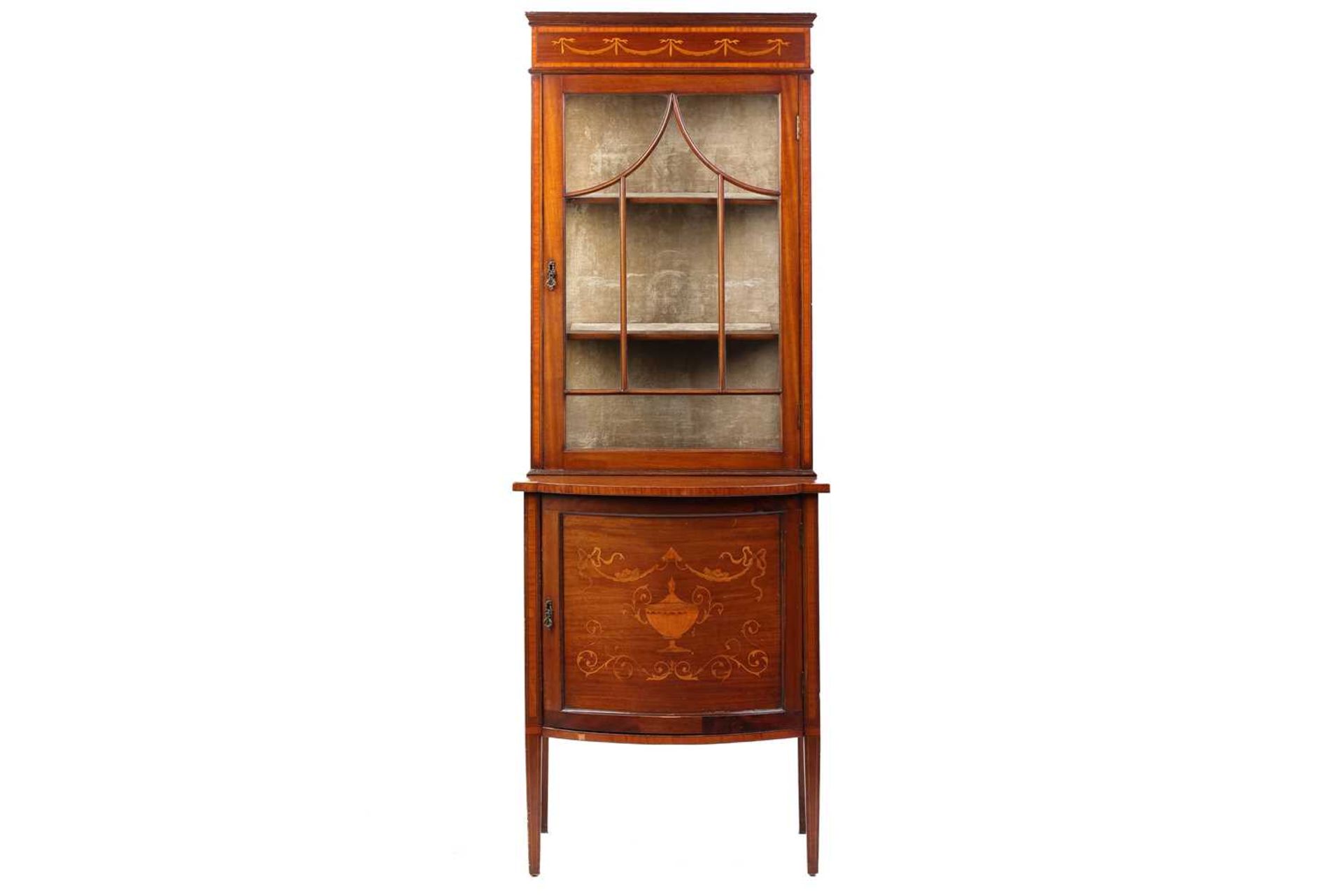 An Edwardian mahogany glazed display cabinet, with 'pagoda arched' astragal glazing, above a bow-