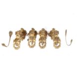 A set of four French ormolu single-sconce wall light brackets with beaded outlines and hanging swags