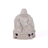 A Chinese blanc de chine figure of Buddha, seated in flowing robes, beads in his right hand, on a