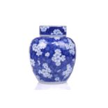 A Chinese porcelain Kangxi style blue & white ginger jar and cover, with blossoming prunus on a