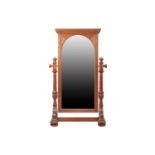 A large late Victorian carved oak cheval dressing mirror with scroll cornicing above an arched
