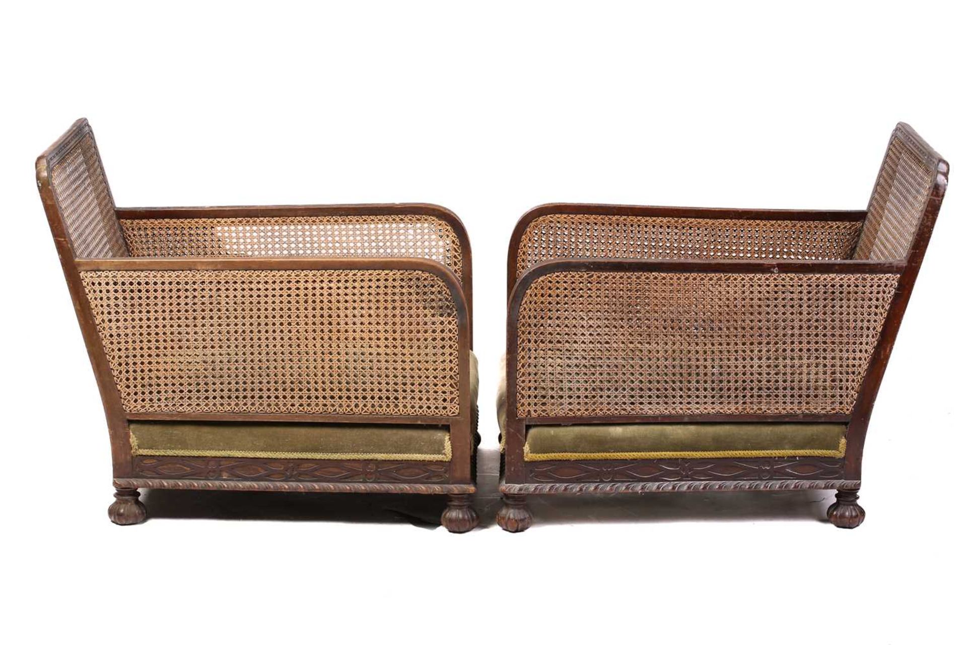 A pair of 1920s oak cane back bergere armchairs, with carved frieze decoration, lacking cushions, 74 - Image 5 of 9