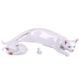 A Royal Copenhagen large white ceramic cat, model 059, 45 cm wide, together with two smaller Royal