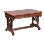 A late Victorian carved mahogany reformed gothic rectangular library table, the top with tooled