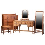 A Gordon Russell bedroom suite in English brown oak, c.1925, comprising: a dressing table with