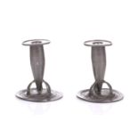 Archibald Knox for Liberty and Co., a pair of English pewter candlesticks, circa 1900, model 0221,