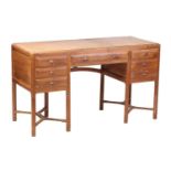 A Gordon Russell Workshops English walnut dressing table, c.1925, with rectangular moulded top,