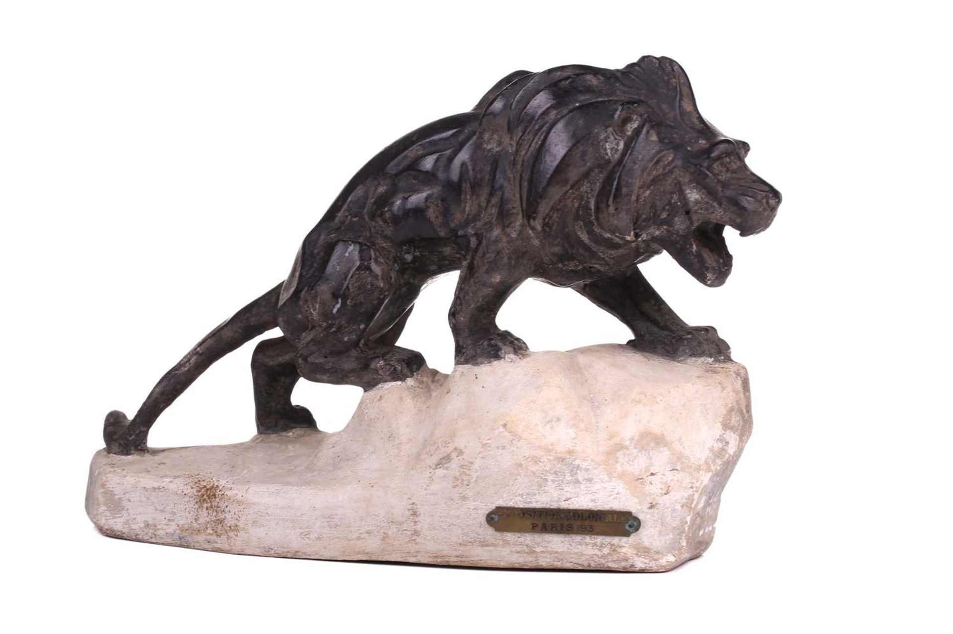 J. Colombini, a patinated composite sculpture of a lion on a rock outcrop, incised signature with