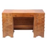 An Arts and Crafts style walnut desk, one long drawer and twelve locking drawers to the left-hand