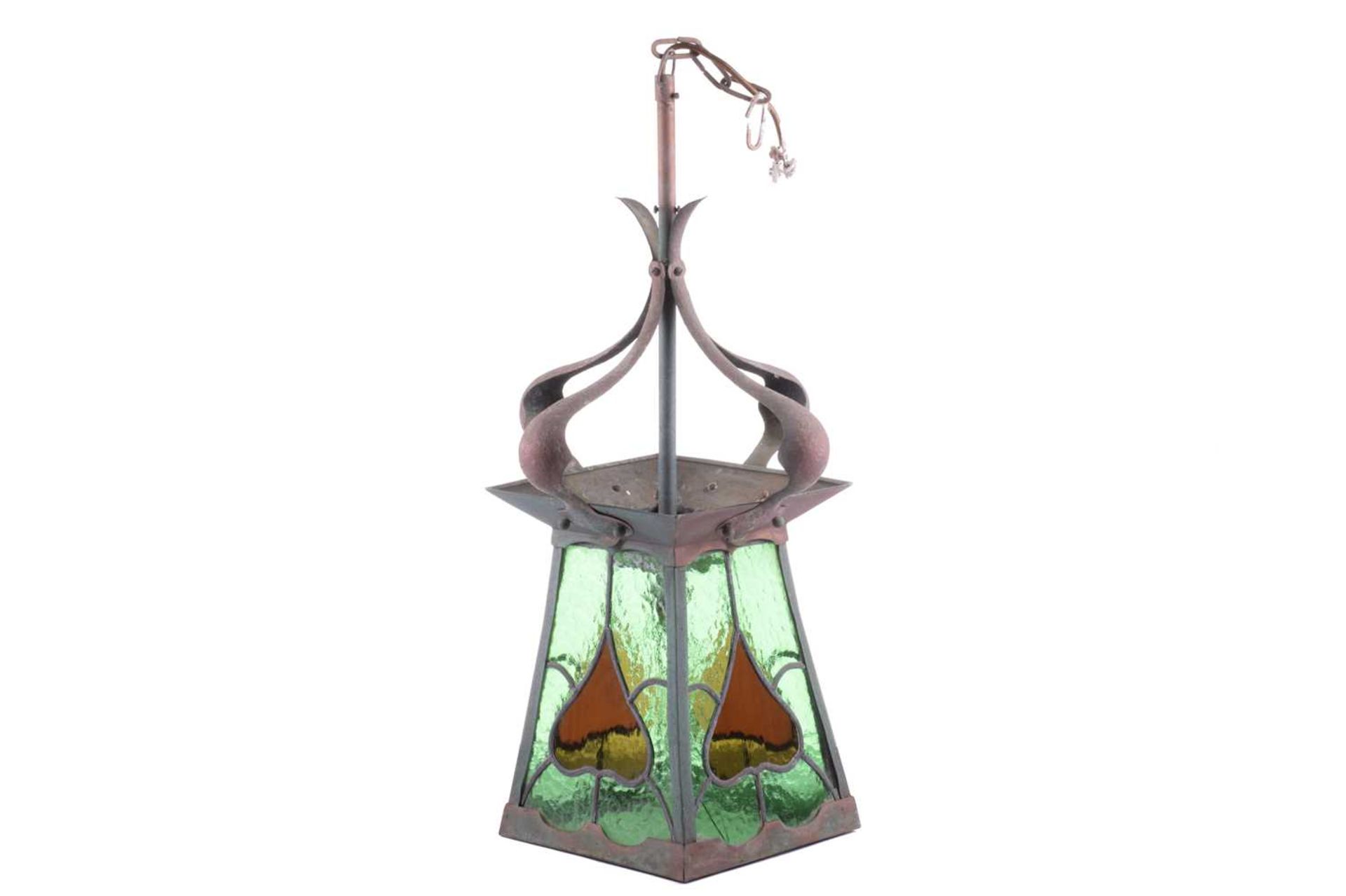 An Arts and Crafts brass and leaded glass ceiling lantern, with four shaped and studded upper