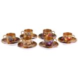 A set of six early 20th century Royal Worcester fruit-painted coffee cans and saucers, variously