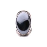 Bent Knudsen - a large hematite cocktail ring, comprising an oval hematite cabochon in a collet