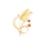 A gold wheat sheaf brooch, measuring 58mm in length, set with red paste, and marked 750 to the