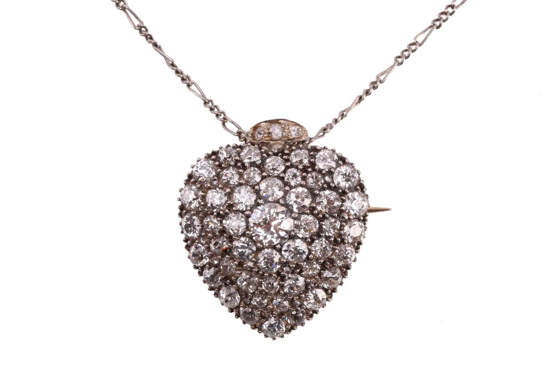 A Victorian diamond heart pendant, circa 1900, set throughout with round old cut diamonds with a