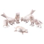 A collection of silver table decorations including a pair of French sparrow pepperettes by Ernest