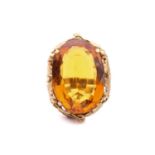 A citrine solitaire ring set with a large oval-cut citrine measuring 26mm x 18.5mm x 9mm, to a