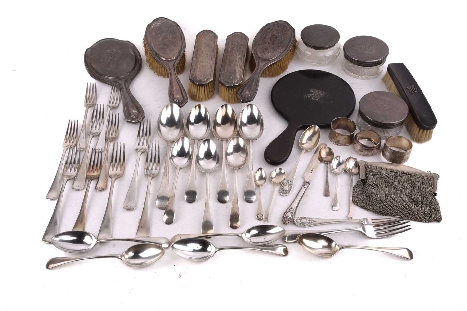 A five piece silver dressing table set; comprising a hand mirror, two hair brushes and a clothes