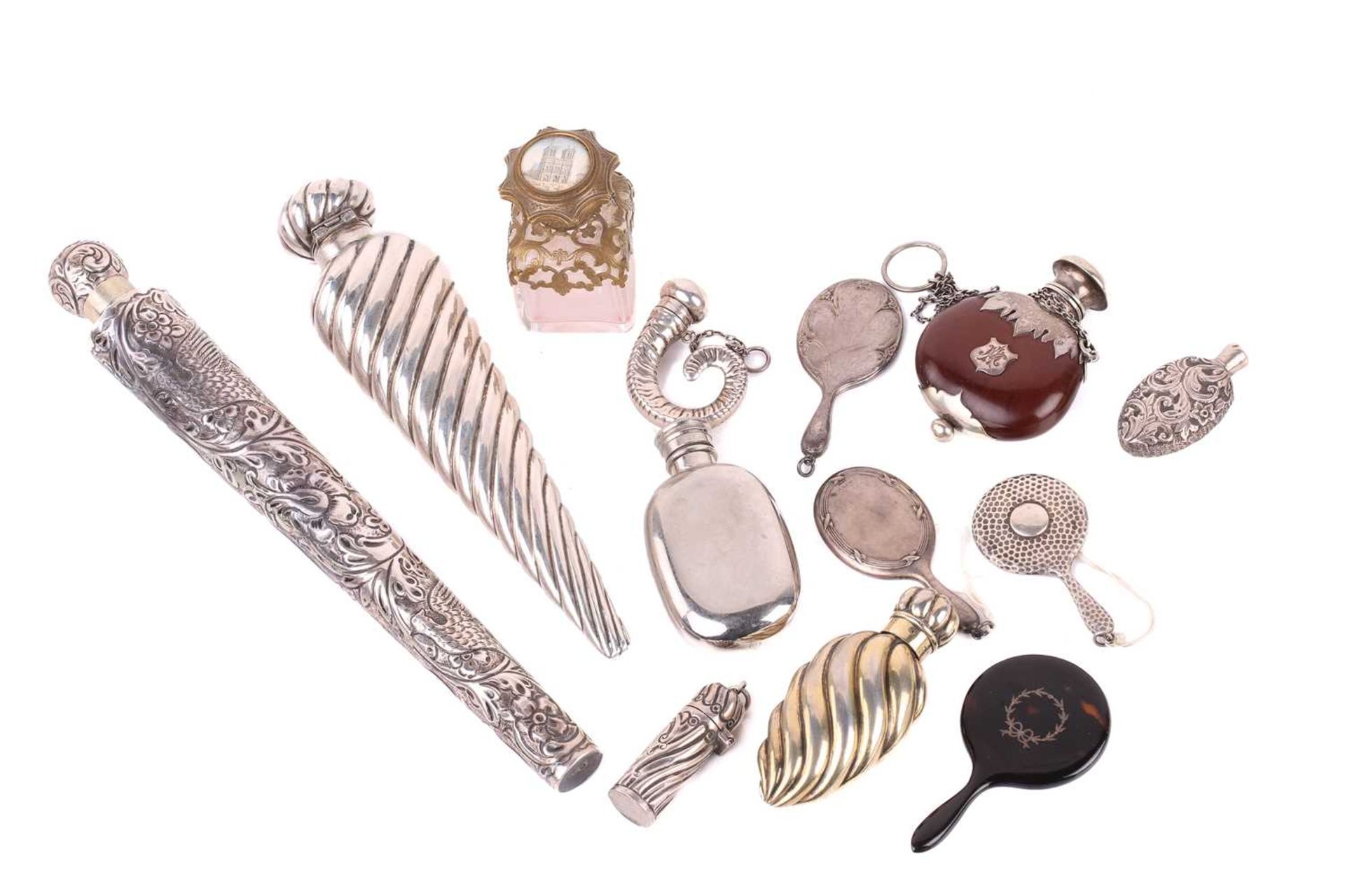 A collection of silver scent bottles, including a large conical with spiral reeded decoration and