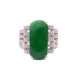 A jade and diamond cocktail ring, featuring a green jadeite of saddle shape, approximately