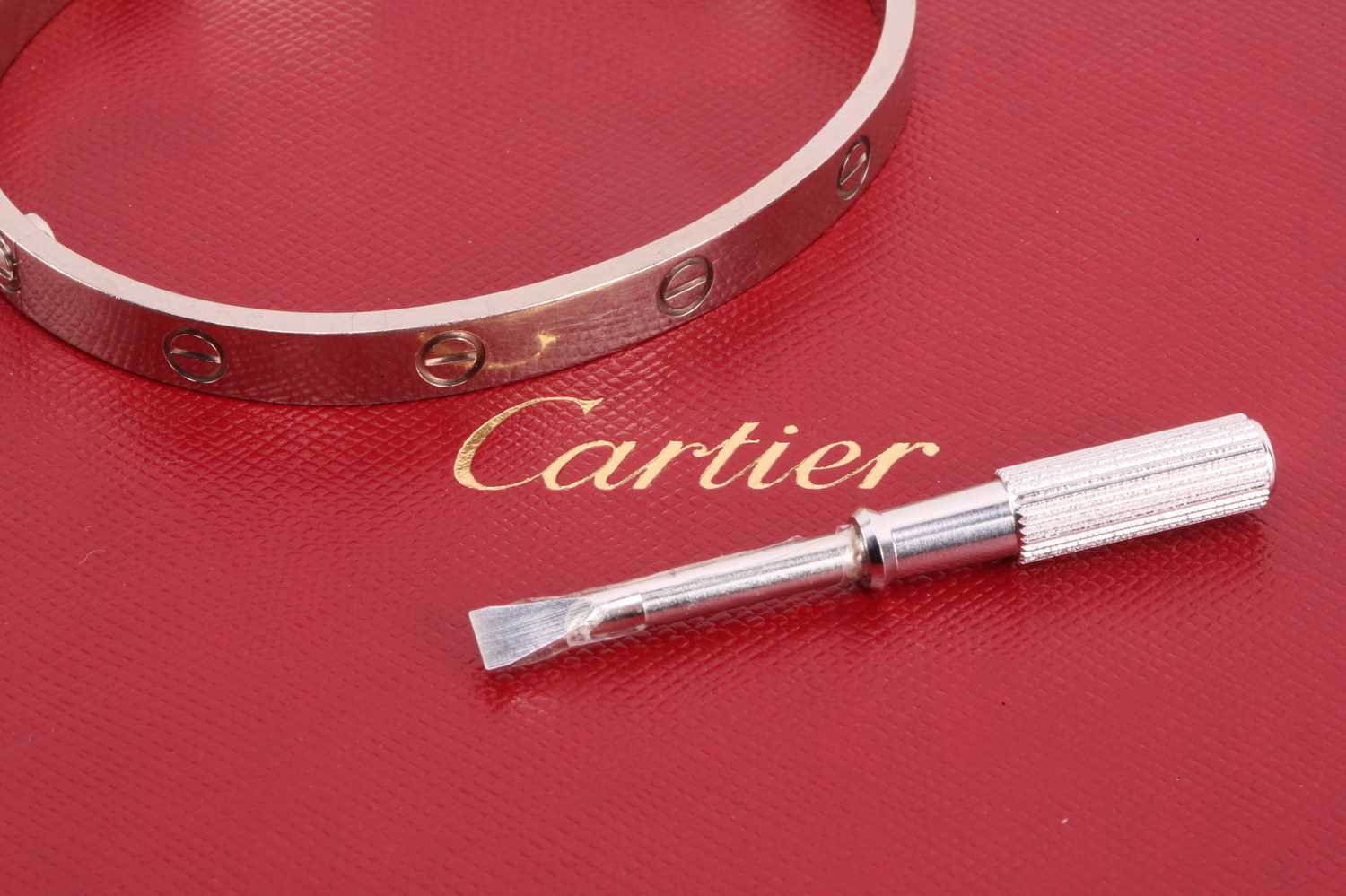 Cartier - a 'LOVE' bangle in 18ct white gold, composed of two rigid arcs with screw motifs, - Image 13 of 17