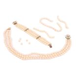 A three string pearl necklace and bracelet suite, the cultured pearls measuring approxmately 7.5mm