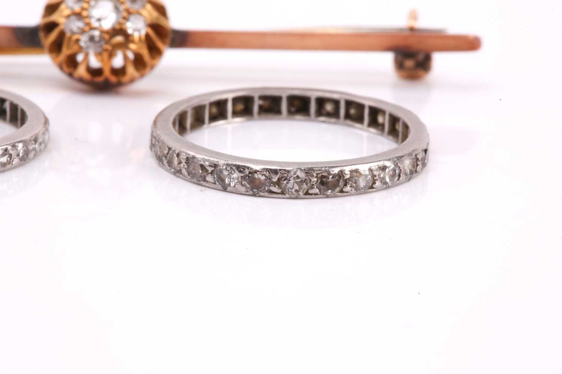 A diamond cluster bar brooch together with two diamond eternity rings. The brooch set with a cluster - Image 5 of 6