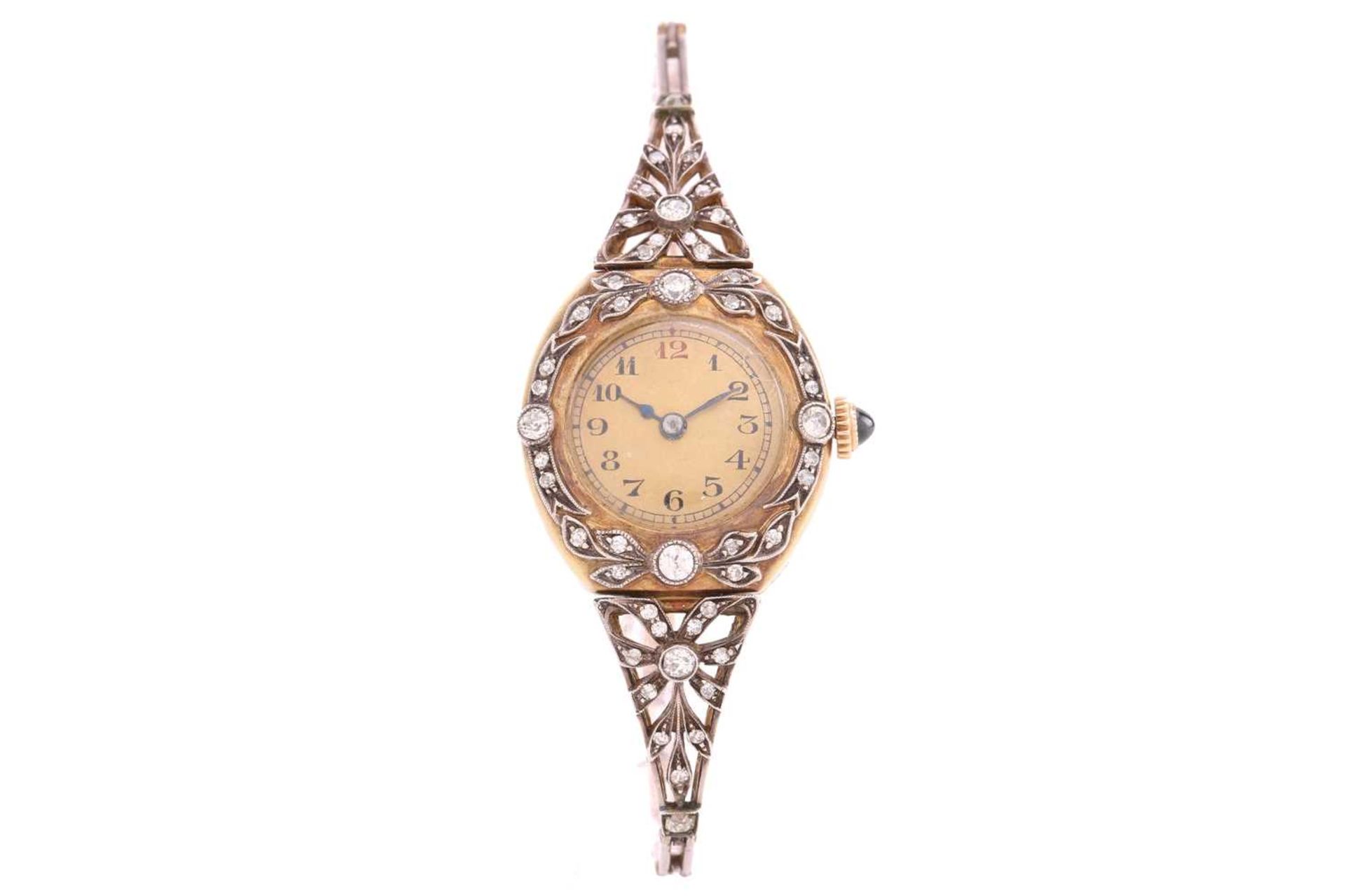 An early 20th century Russian ladies gold and diamond set wristwatch, the silvered dial with