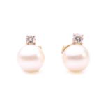 A pair of cultured pearl and diamond stud earrings, each featuring a round cultured pearl of 7.7 mm,
