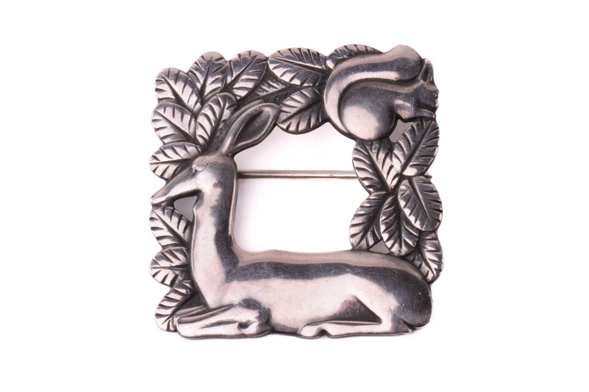 Georg Jensen - a square openwork brooch in silver, featuring a resting deer and squirrel in foliage,