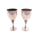 Georg Jensen - a pair of small wine goblets, both with a hammered finish on a stemmed base with