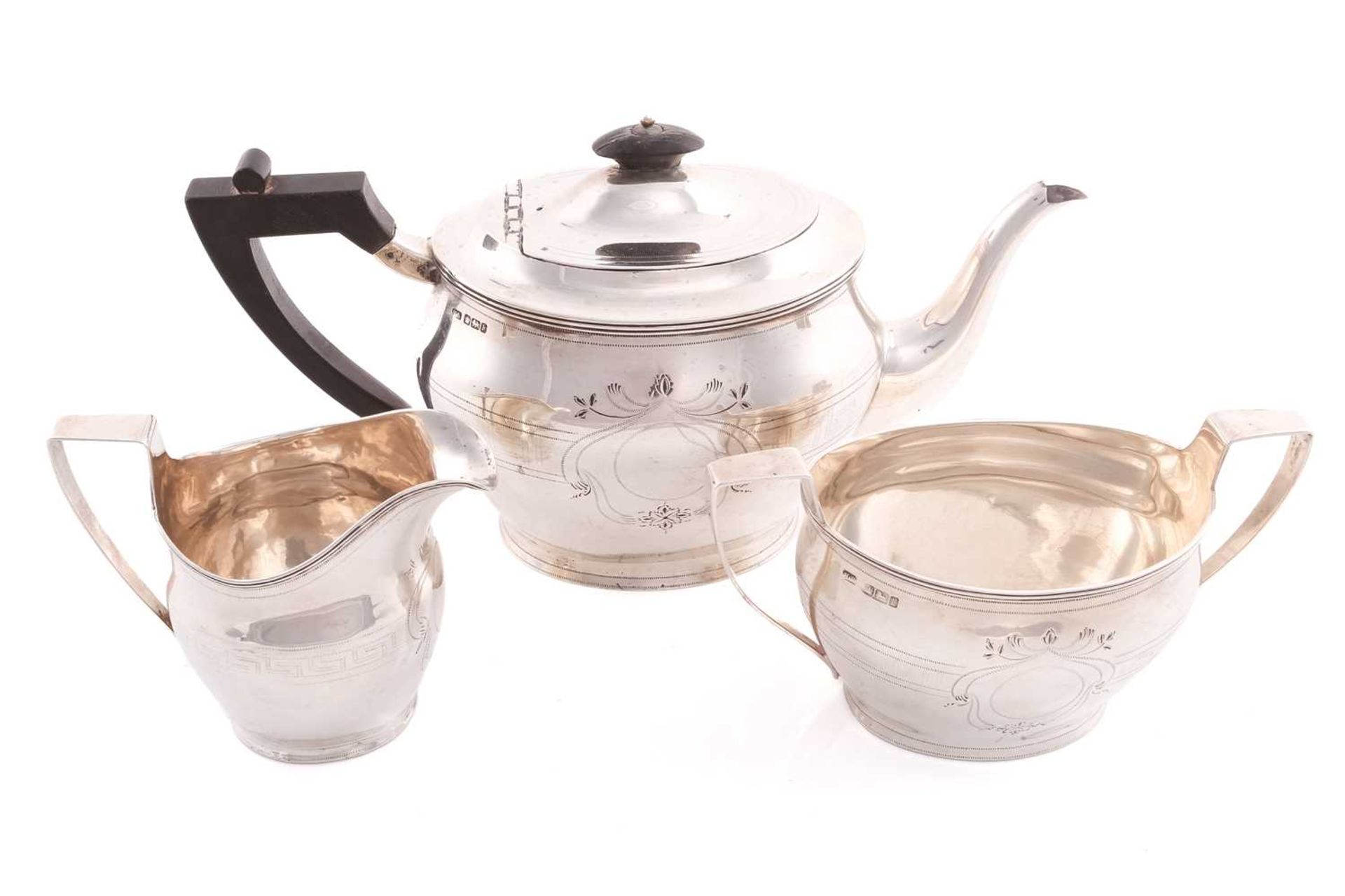 An Edward VII three-piece silver tea set, Sheffield 1902 by Henry Stratford, comprising a teapot