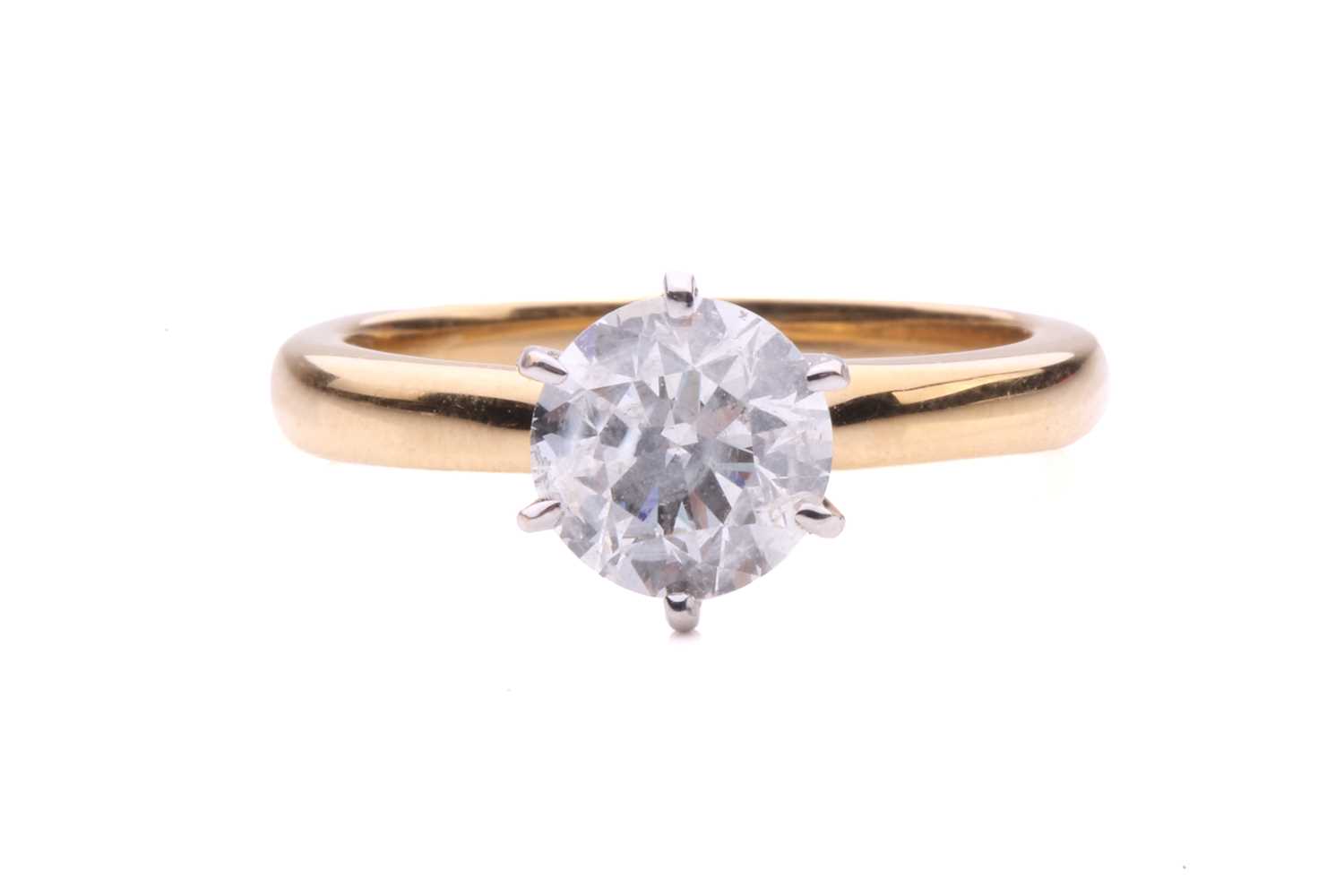 A diamond solitaire ring in 18ct gold, centred with a brilliant-cut diamond of 6.7 mm with an