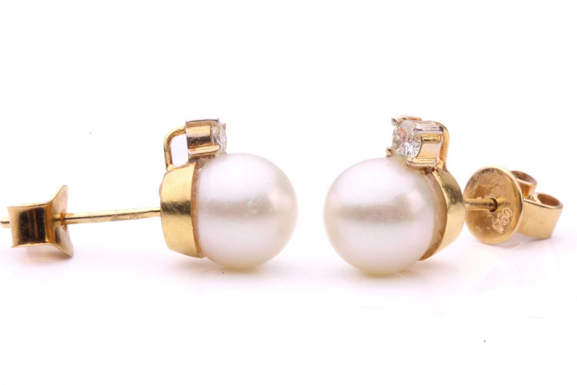 A pair of cultured pearl and diamond stud earrings, each featuring a round cultured pearl of 7.7 mm, - Image 2 of 3